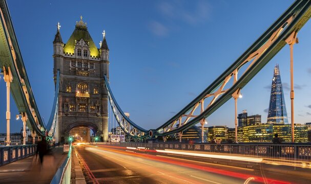 Tower Bridge in the evening, light traces of passing cars, in the back skyscraper the Shard, London, England, Great Britain