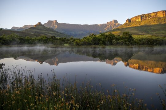 Sunrise, amphitheatre with reflection in the lake, Royal Natal National Park, Drakensberg Mountains south, Kwa Zulu Natal, South Africa