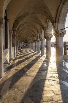 Sun shining in portico at Doge's Palace, St. Mark's Square, Venice, Veneto, Italy