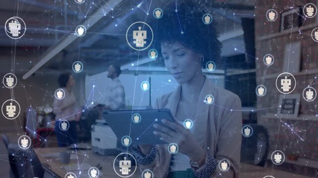 Woman tapping tablet at desk in business causing network overlay linking bot or user icons, data syn