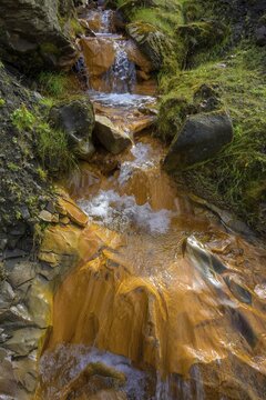 Stream coloured orange by iron oxide, Selvellir, Stykkish&oacute;lmur, Vesturland, Iceland