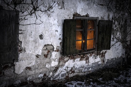 Old decayed wooden window on old house facade in candlelight, Mindelheim, Unterallg&auml;u, Bavaria, Germany