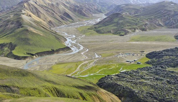 View from Su&eth;urn&aacute;mur Mountain over the Laugahraun lava field with cabins and a camping site, Landmannalaugar, Southern Region, Iceland