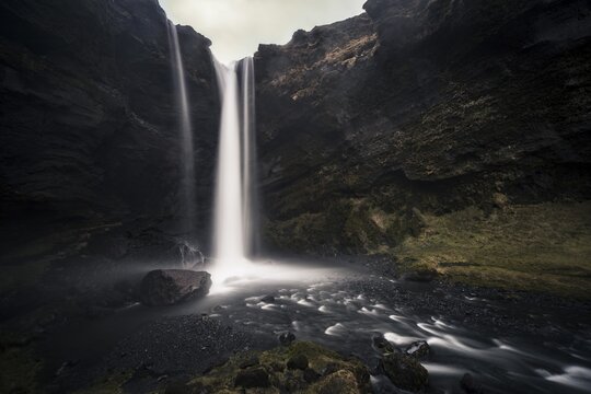 Waterfall Kvernufoss in a gorge, dramatic dark atmosphere, time exposure, near Sk&oacute;gafoss, Southurland, Iceland