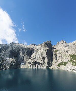 Mountain lake Lac de Melo surrounded by cliffs, source of the Restonica river, Restonica mountain valley, Corte, Haute-Corse, Corsica, France