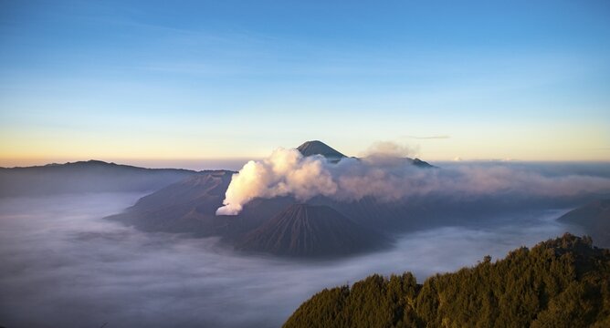 View of volcanoes at sunrise, smoking volcano Gunung Bromo, Batok, Kursi, Gunung Semeru, Bromo-Tengger-Semeru National Park, Java, Indonesia