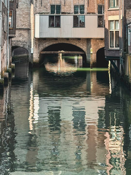 Stadshuis arches reflected in calm canal waters of Voorstraathaven