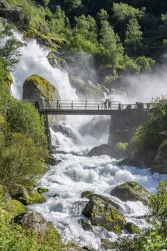 River Briksdalselva, Hike to the Briksdalsbreen, Bridge at the waterfall Kleivafossen, Briksdal, Norway