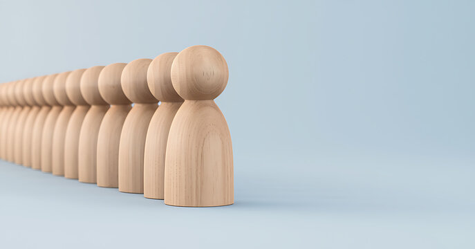 A line of identical wooden peg dolls standing in a row representing uniformity and conformity now