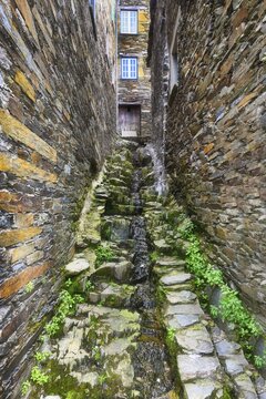 Narrow cobbled street and schist houses in the medieval mountain village of Piodao, Serra da Estrela, Beira Alta, Portugal