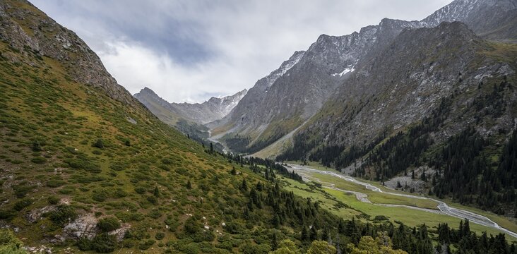 Green mountain valley with river and steep mountain peaks, Chong Kyzyl Suu Valley, Terskey Ala Too, Tien-Shan Mountains, Kyrgyzstan