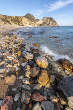 Beach with coloured stones, sandy beach with rocky cliffs, Paralia Paradisos, Kos, Dodecanese, Greece