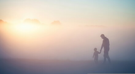 Fototapeta premium Silhouetted father and child walking towards a bright sunset on a beach