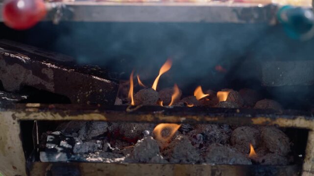 Charcoal grill fire with burning briquettes and hot coals for barbecue cooking and outdoor grilling, 4K