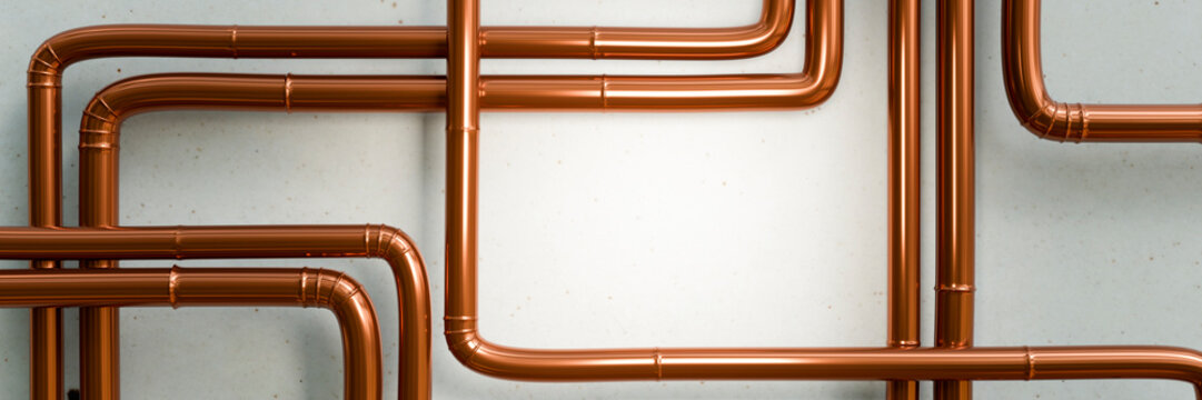 Polished copper pipes arranged in a complex network against a textured wall
