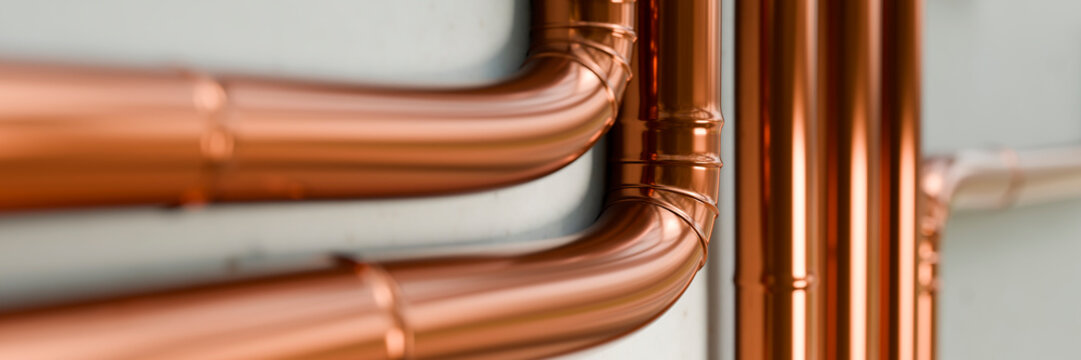 Polished copper pipes with clean bends and joints, reflecting light beautifully