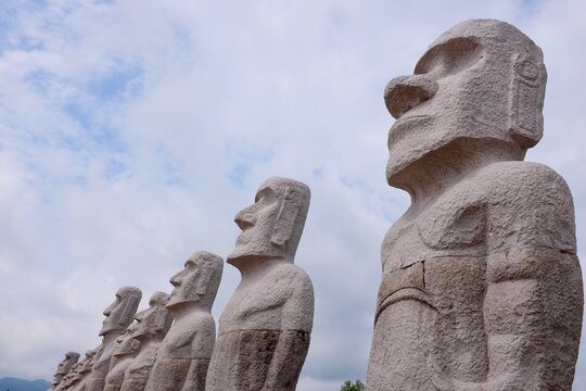 SAPPORO, JAPAN &ndash; JULY 27, 2025: A line of monolithic Moai statue replicas standing tall at the Makomanai Takino Cemetery in Hokkaido, a popular architectural and cultural landmark.
