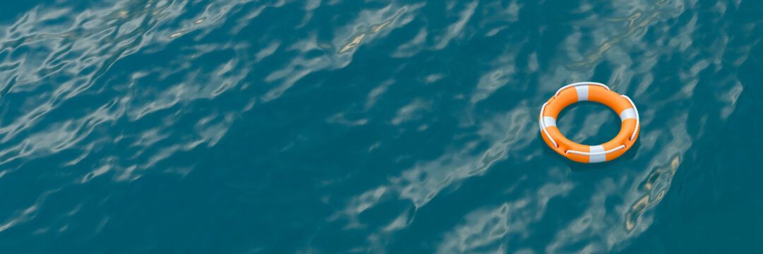 Orange life preserver ring floating alone on the vast blue ocean surface