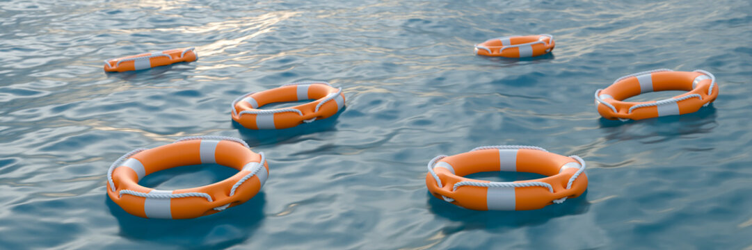 Multiple orange life preservers floating on rippling blue water surface