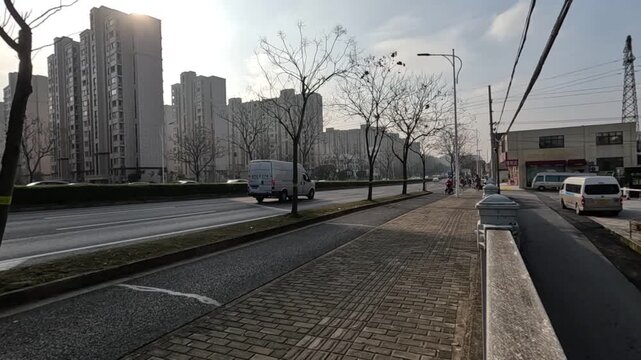 Shanghai China urban street road sidewalk city winter morning near apartment building with quiet empty road, bare tree line, van under bright sky, SEO friendly searchable title