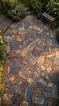 Sunlit flagstone patio pathway with bench and surrounding greenery.
