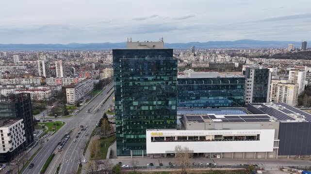 Sofia, Bulgaria - aerial view of Bulgaria Mall and adjacent glass office tower with city traffic and urban skyline