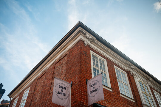 Bussi & Amore Bistro in the Historic Dutch Quarter. Low angle shot of the red brick facade of Bussi & Amore bistro with white flags in the Dutch Quarter of Potsdam, Germany - January 16 2026.