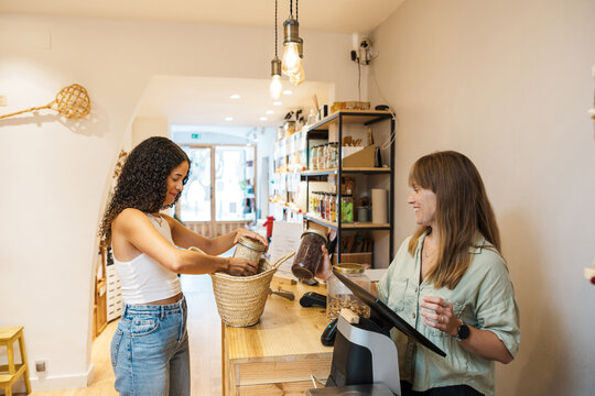 Customers shopping bulk organic food in zero waste store