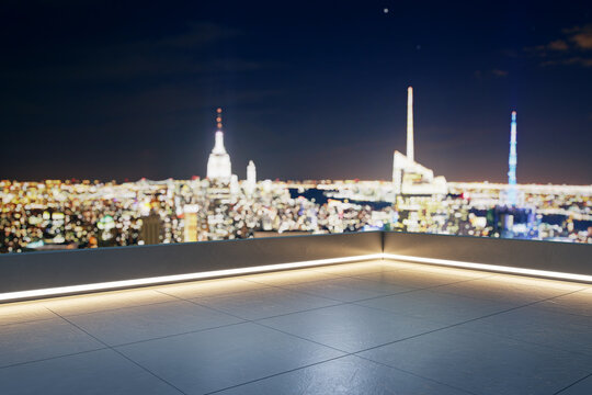 Empty modern rooftop terrace with illuminated edge overlooking blurred night city skyline and open copyspace for branding template. 3D Rendering