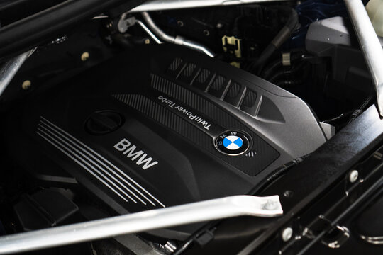Twin Power Turbo gasoline engine. BMW X6 G06 sport engine or motor under vehicle hood. Close up detail of new car engine. Engine motor of BMW car close-up with emblem on centre close-up.