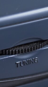Tuning wheel with sharp ridges creates tactile control element. Mechanical interaction reflects analog past. Old retro radio or cassette player with radio function