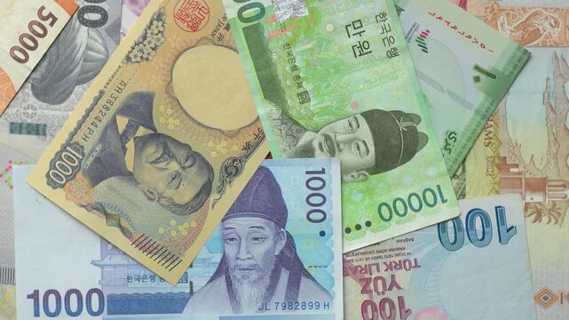 World international banknotes rotating footage. Chinese Yuan, Korean Won, Indonesian Rupiah, Turkish Lira, Japanese Yen, Iranian Rial. Business currency finance background