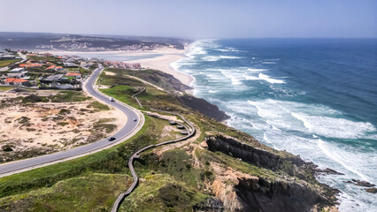 Obraz premium Foz do Arelho, Portugal - Winding coastal road near cliffside beach with ocean waves crashing