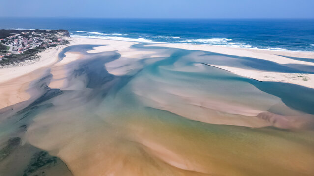 Foz do Arelho, Portugal - Top-down coastal scene with sandy dunes and ocean waves
