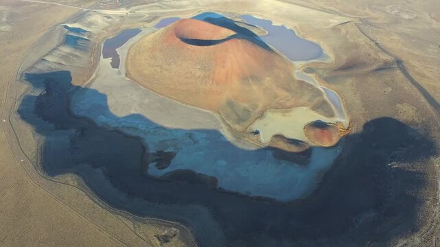 Aerial view of tuff ring cone and volcanic crater lake maar in a barren caldera of Konya Turkiye. Rocky terrain, topography, wilderness, anatolia depict rugged regional geology natural history.