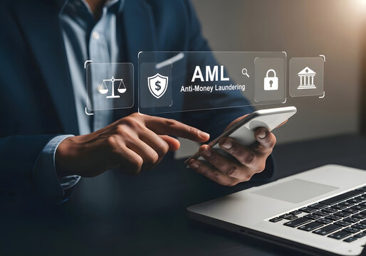 Businessman using a smartphone and laptop for anti-money laundering and financial security purposes.