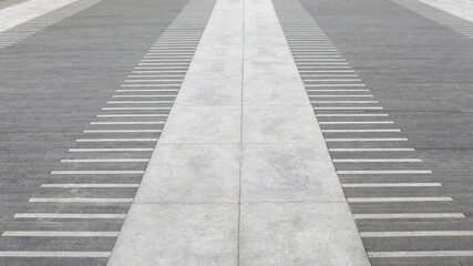 Fototapeta premium Pavement perspective creating a sense of direction and progress, featuring contrasting gray tones and a harmonious blend of abstract patterns with geometric lines