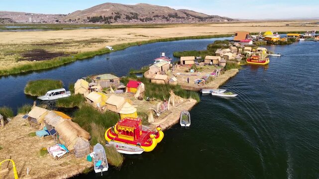 Aerial drone view of the floating Uros Islands on Lake Titicaca. The highest navigable lake in the world, located near Puno, Peru, South America. Popular travel destination.	