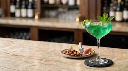 Fototapeta premium Green cocktail garnished with mint served on marble bar