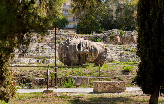 Syracuse, Sicily, Italy - October 1, 2024: Fragmented colossal face sculpture by Polish artist Igor Mitoraj exhibited in the Neapolis Archaeological Park in Syracuse.