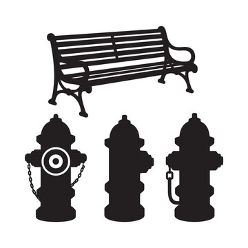 Black silhouettes of a park bench and three fire hydrants