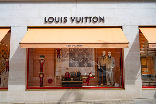 Louis Vuitton London New Bond Street flag ship luxury store front and brand logo, the fashion business located in the popular high end shopping district of Mayfair, London, UK.
