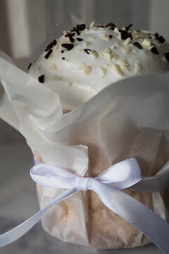 Easter kulich with icing and chocolate sprinkles, close-up.