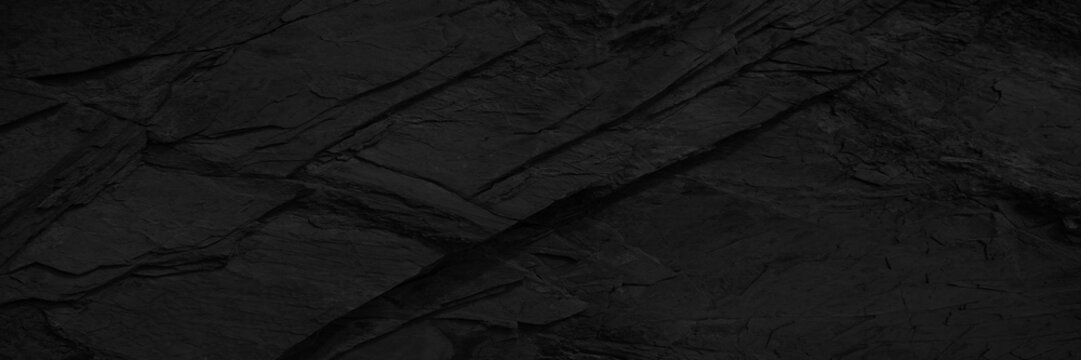 Black white dark gray rock stone granite texture background. Mountain surface. Close-up. Grunge rough solid hard. Design. Wide banner. Panoramic.