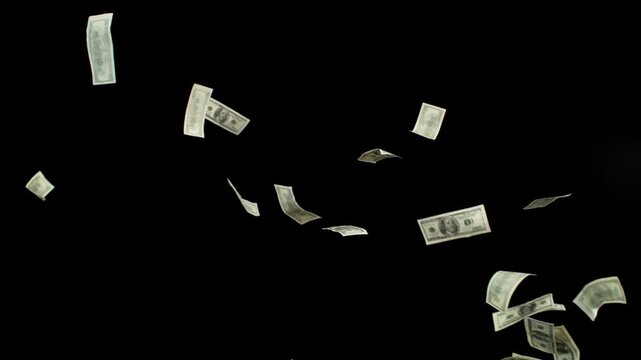 Super slow motion of flying US dollars banknotes on black background. Filmed on high speed cinema camera, 1000fps.