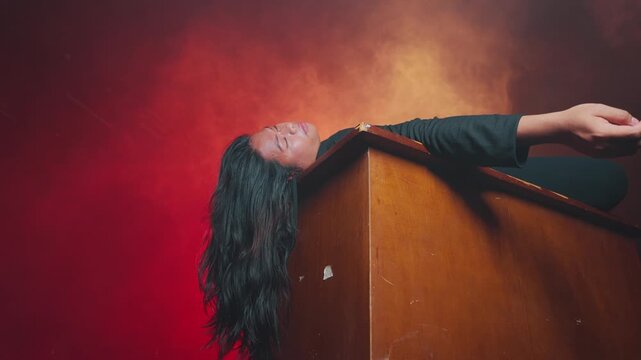 A young woman lies unconscious on a wooden surface bathed in red lighting and heavy fog. The cinematic composition evokes feelings of a dark fairy tale, sleep paralysis, or a psychological thriller.