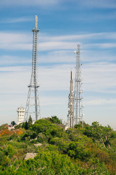 Telecom towers with antennas under blue sky