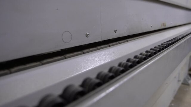Close view of a conveyor system in a factory, showing the path used to transport goods