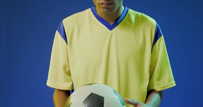 Upward pan starting soccer player shifting, centering mono ball, then raising gaze for portrait