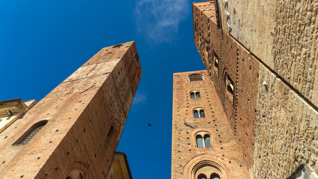 Towers of the old town hall in the medieval historic center with towers and ancient buildings in the Ligurian village of Albenga, province of Savona, Liguria, northern Italy
